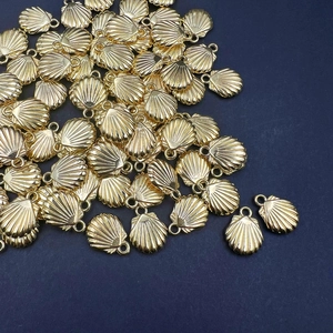 Golden starfish shell pendants for DIY necklaces and bracelets on navy texture