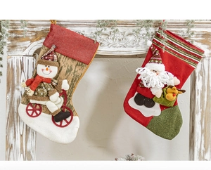 Detail of knitted Christmas stockings with 3D Santa and Reindeer hanging on a fireplace
