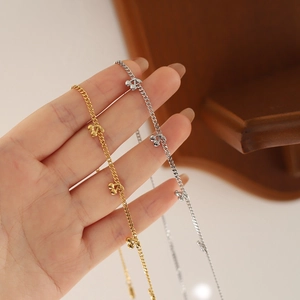 Delicate cherry pendant necklace in gold and silver finish with fine cable chain links