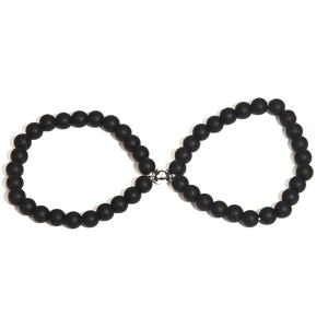 Close-up of black matte bead bracelets with silver magnetic clasp in infinity shape