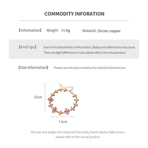 Detail of 18K gold-plated copper bracelet featuring zircon floral links and 22cm adjustable chain