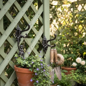 Vintage monkey-shaped cast iron triple wall hook for rustic home decor and entryway storage