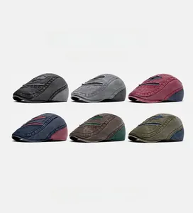 Detail showing various colors of vintage washed denim flat caps with Boston embroidery