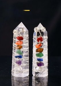 Detail of silver wire wrapped clear quartz energy wand with seven chakra healing stones