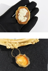 Macro view showing the dual-use brooch pin and necklace pendant hook on a gold vintage cameo