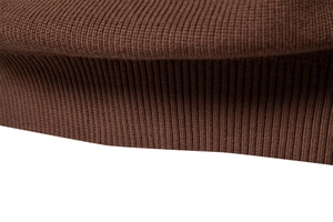 Macro shot of brown ribbed knit sweater texture showing high quality fabric details