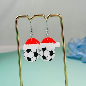 Christmas football earrings with festive Santa hats on a golden metal display stand