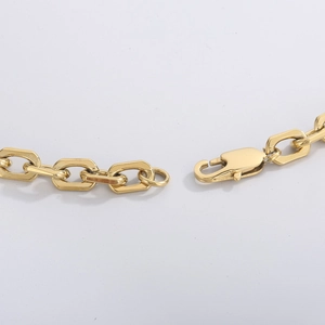 Close-up of gold stainless steel lobster clasp and flat oval chain links detail