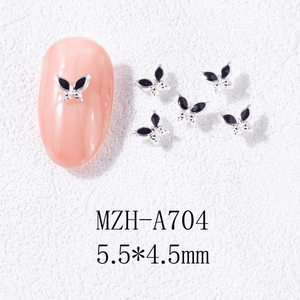 Macro shot of 5.5x4.5mm black and silver mini butterfly alloy nail art charms