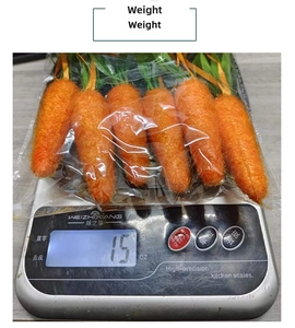 Weight measurement of six orange artificial carrots with green leaves in clear packaging