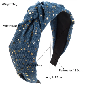 Blue denim knotted headband with shiny golden stars and comfortable black padded ends
