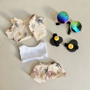 Flat lay of miniature doll outfit set with pink elephant shirt and duck shoes