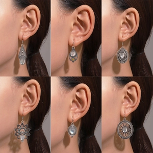 Bohemian silver drop earrings set with turquoise and moonstone in various vintage patterns