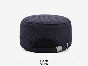 Back view of navy quilted flat top cap showing silver buckle and elastic detail