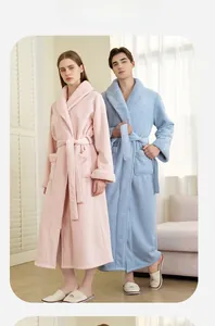 Detail of adjustable belt and thick coral fleece texture on couple's warm winter bathrobe