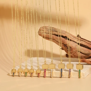 Set of 10 gold key necklaces featuring colorful zircon square pendants on stone base