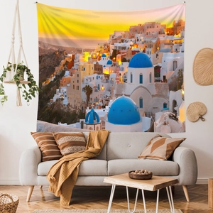 Detail view of large Santorini sunset tapestry showing blue dome churches in a cozy living room