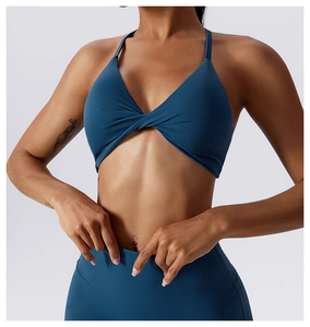 Detailed close-up of dark blue sports bra with front knot design and high waist leggings