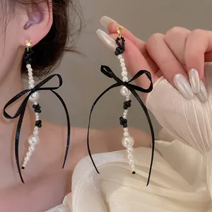Elegant bowknot pearl tassel earrings with gold studs and black ribbons for women