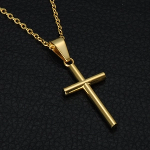 Polished minimalist gold stainless steel cross pendant necklace on black textured leather