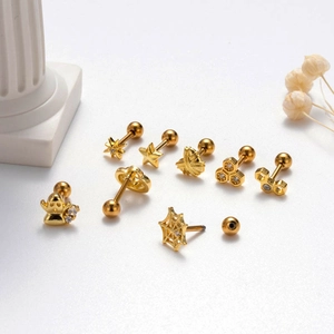 Golden Halloween punk ear studs set featuring spider web, bee and star motifs on white background