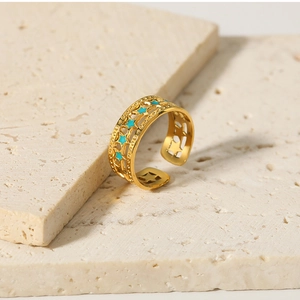 Detailed shot of 18K gold plated star ring with turquoise enamel on stone base