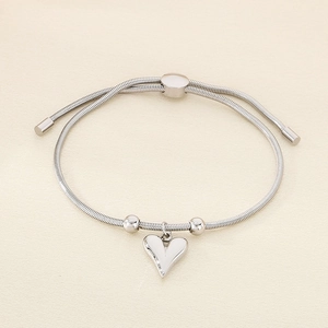 Detail of adjustable silver heart charm snake chain bracelet with sliding ball clasp closure