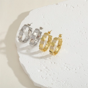Elegant gold and silver C-shaped zircon hoop earrings with serpent scale texture