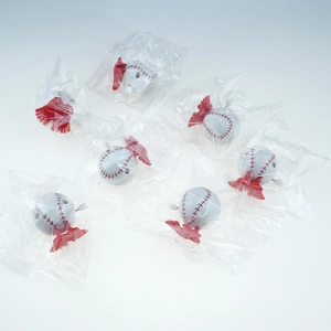 Detailed view of individual wind-up baseball toys in clear poly bag packaging