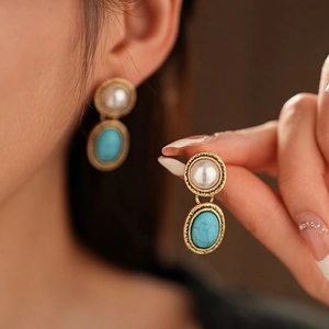 Vintage jewelry set with round pearl and turquoise stone in gold textured settings