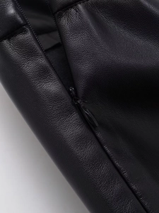 Primer plano de la falda de cuero PU negro con textura de lichi y cremallera a juego