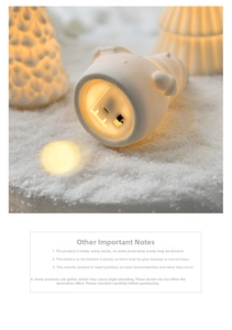 Close-up of ceramic Christmas house base showing battery compartment and LED switch