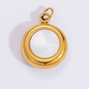 Macro view of a circular gold 18k titanium steel photo frame pendant with a clear glass center