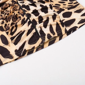 Detailed view of leopard print fabric showing ruched texture and durable overlock stitching