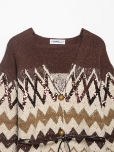 Close-up of brown jacquard knit cardigan with wave patterns, sequins and slim leather belt