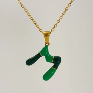 Golden letter M pendant necklace with green enamel inlay for personalized jewelry style