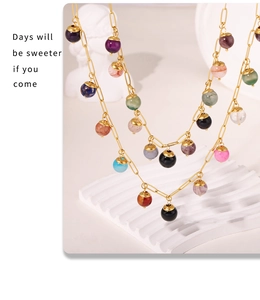 Detail shot of boho necklace featuring colorful natural stones on golden chain link