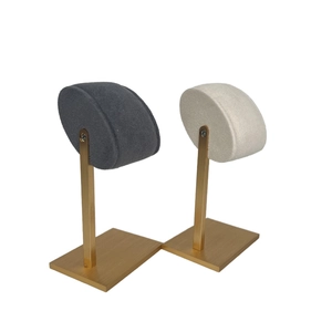Close-up of velvet oval pads and golden metal frame for jewelry and watch display
