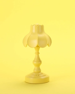 Dettaglio del paralume a petalo giallo su una lampada da notte LED retrò minimalista