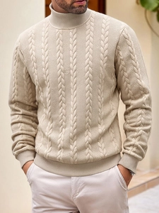 Detailed close-up of beige cable knit patterns on a men's stylish turtleneck sweater