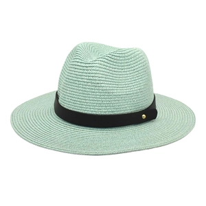 Detailed weave texture of a mint green paper straw panama hat with black faux leather band