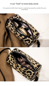 Detailed interior of vintage leopard print cylinder bag showing storage for makeup