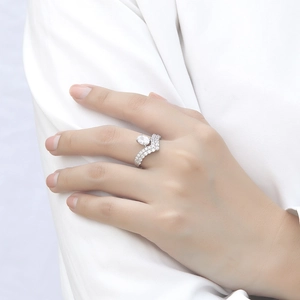 Macro detail of oval zircon ring in sterling silver showing wave pavé band and gem shine