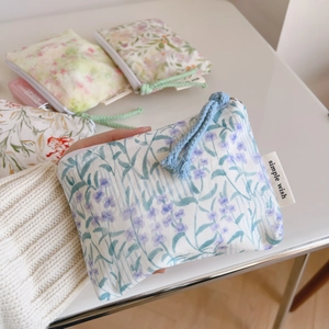 Detailed macro view of floral cotton pouches with colorful woven drawstring closure