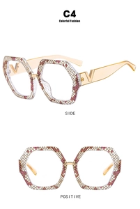 Detailed view of pink snake pattern frames with rhinestones and golden V hinge detail