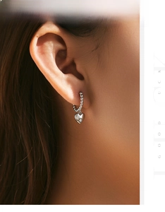 Detailed view of S925 silver beaded hoop earring with a sparkling heart pendant on ear