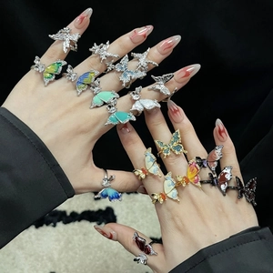 Colorful butterfly enamel rings with rhinestones shown on hand in various styles