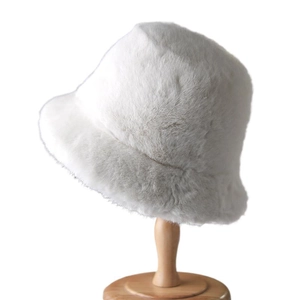 Plush faux fur bucket hat in white, soft winter fisherman cap on wooden mannequin head
