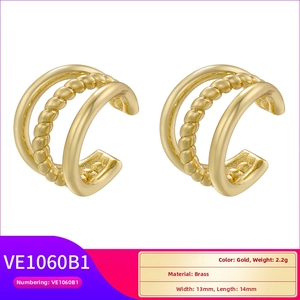 Detail view of triple layer gold brass ear cuff showing twisted texture and mirror finish