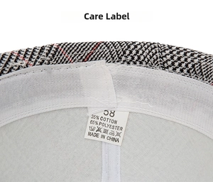 Care label detail of plaid fedora hat showing 35% cotton 65% polyester material and size 58